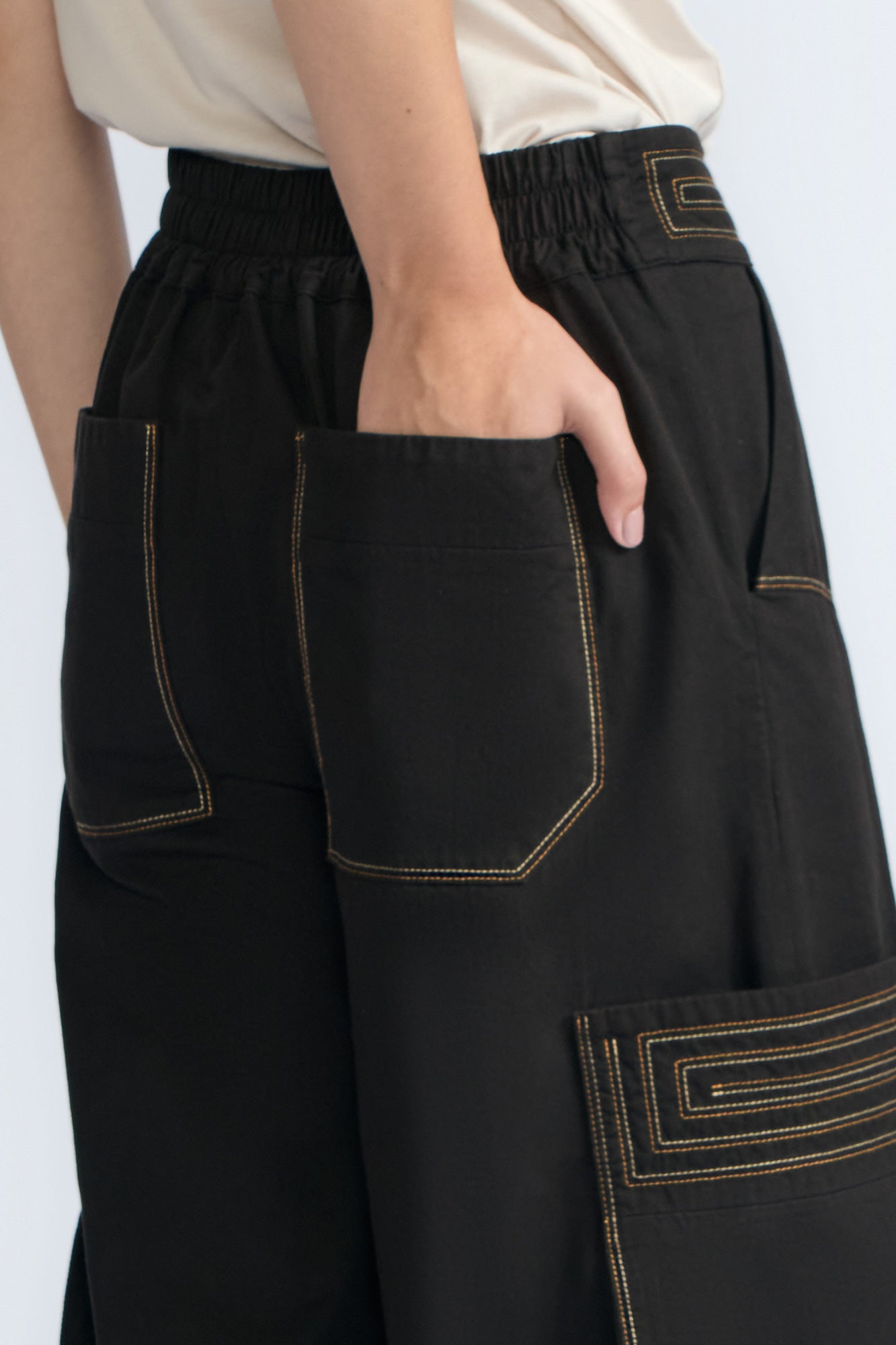 Bela Pant in Black – Cropped cotton palazzo pants with side flap pockets, elasticated waist, and contrast stitching.
