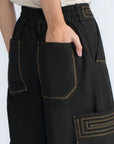 Bela Pant in Black – Cropped cotton palazzo pants with side flap pockets, elasticated waist, and contrast stitching.