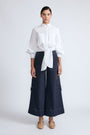 Belen Pant in Navy – Cotton palazzo trousers with side patch pockets, metal buckle details, and a wide waistband.