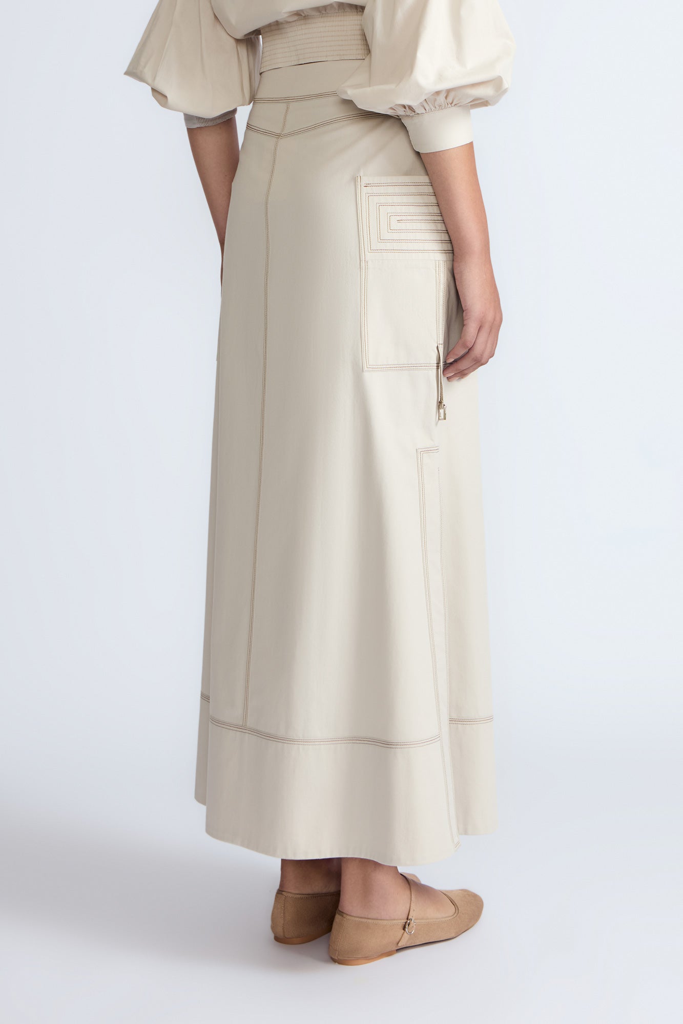 Belen Skirt in Prestine – Cotton maxi skirt with patch pockets, buckle straps, wide waistband, and contrast stitching.