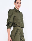 Side profile of the Olive Bimba Blouse, highlighting the dramatic volume of the puff sleeves.
