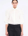 The Bimba Blouse in classic white, featuring its crisp shirt collar and relaxed fit.
