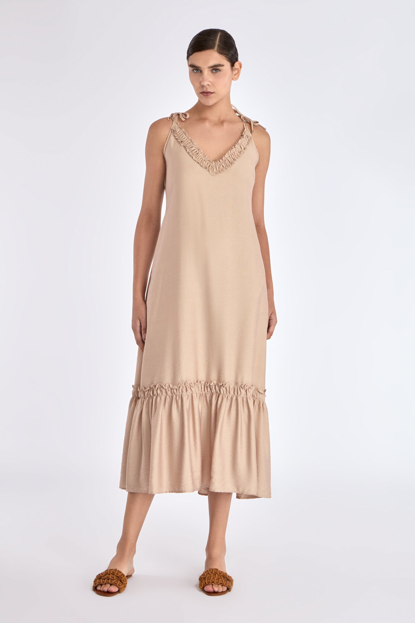 The Blake Maxi Dress in a sophisticated Nude, highlighting its romantic ruffle neckline.