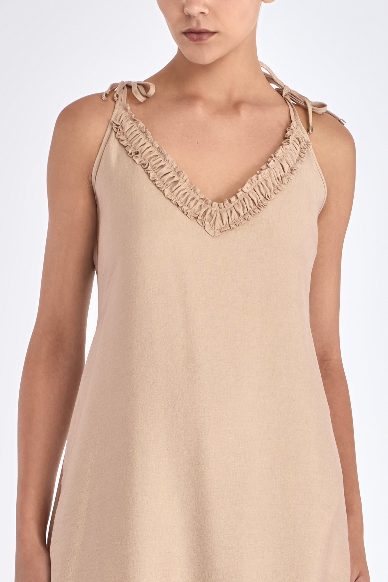 The Blake Maxi Dress in a sophisticated Nude, highlighting its romantic ruffle neckline.