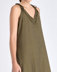 Close-up of the delicate ruffle and double strap with metal accents on the Olive Blake Dress.