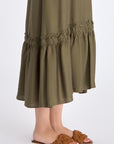 Close-up of the delicate ruffle and double strap with metal accents on the Olive Blake Dress.