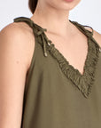 Close-up of the delicate ruffle and double strap with metal accents on the Olive Blake Dress.