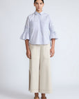 Callie Blouse – 100% cotton shirt blouse with hidden buttons, ¾ sleeves, and smocked cuffs and pockets. Made in Peru.