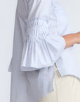 Callie Blouse – 100% cotton shirt blouse with hidden buttons, ¾ sleeves, and smocked cuffs and pockets. Made in Peru.