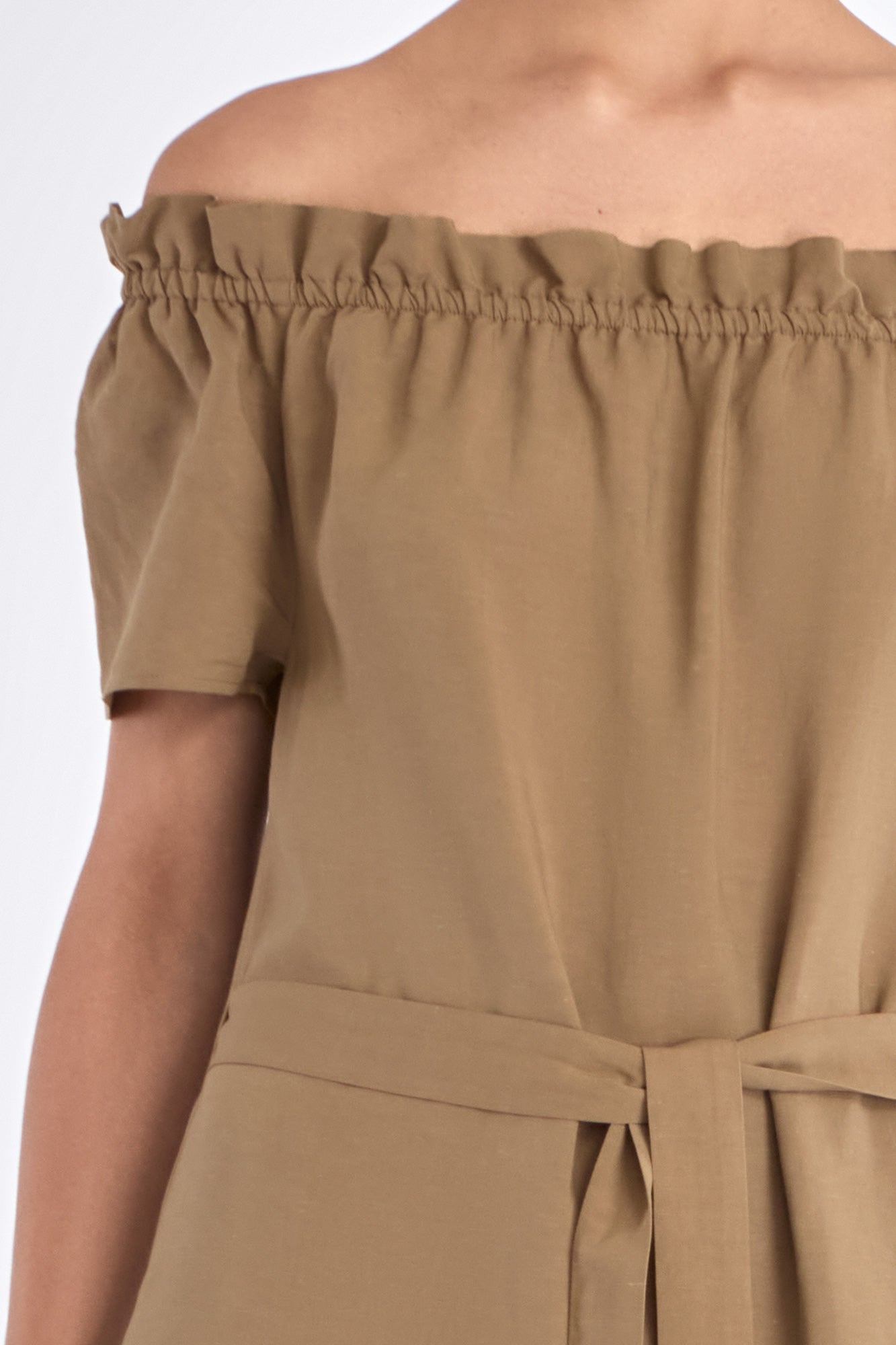 Close-up of the exquisite, handcrafted AMEDBAM embroidery on the hem of the Taupe Cameron Dress.