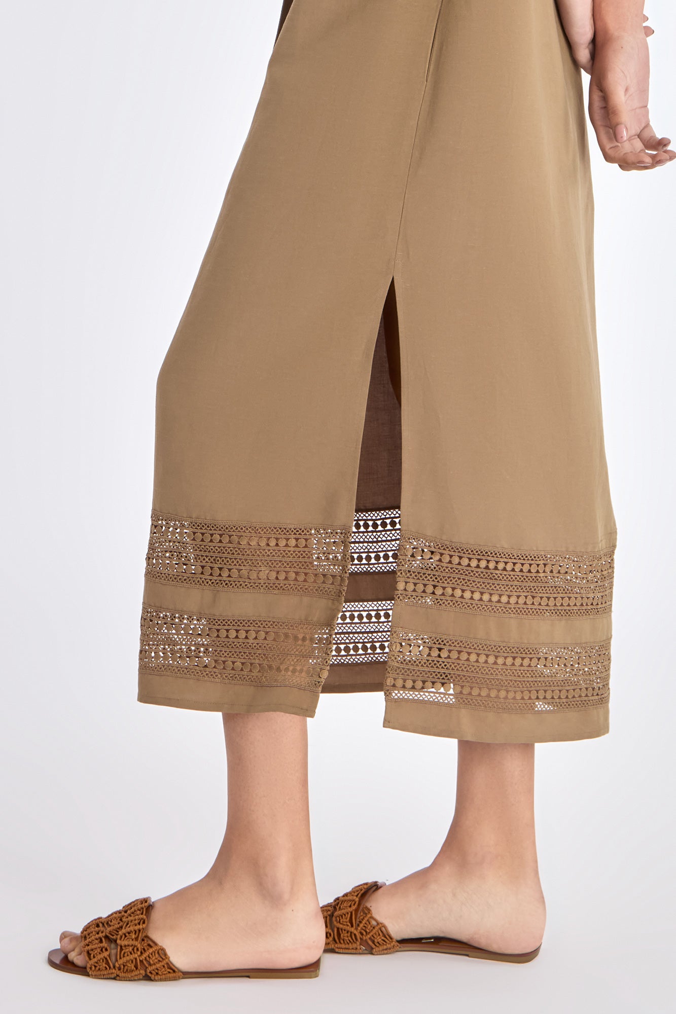 Close-up of the exquisite, handcrafted AMEDBAM embroidery on the hem of the Taupe Cameron Dress.