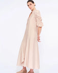 Side profile of the Nude Carlie Dress, highlighting the dramatic volume of the puff sleeves.