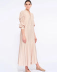 Side profile of the Nude Carlie Dress, highlighting the dramatic volume of the puff sleeves.