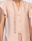 Chaya silk blouse in blush with a V-neckline and waist tie