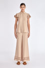 The Clark Blouse in a sophisticated Nude, featuring its crisp shirt collar and hidden button placket.