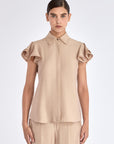 The Clark Blouse in a sophisticated Nude, featuring its crisp shirt collar and hidden button placket.