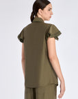 Clean back silhouette of the Clark Blouse, showing the elegant drape of the woven fabric.