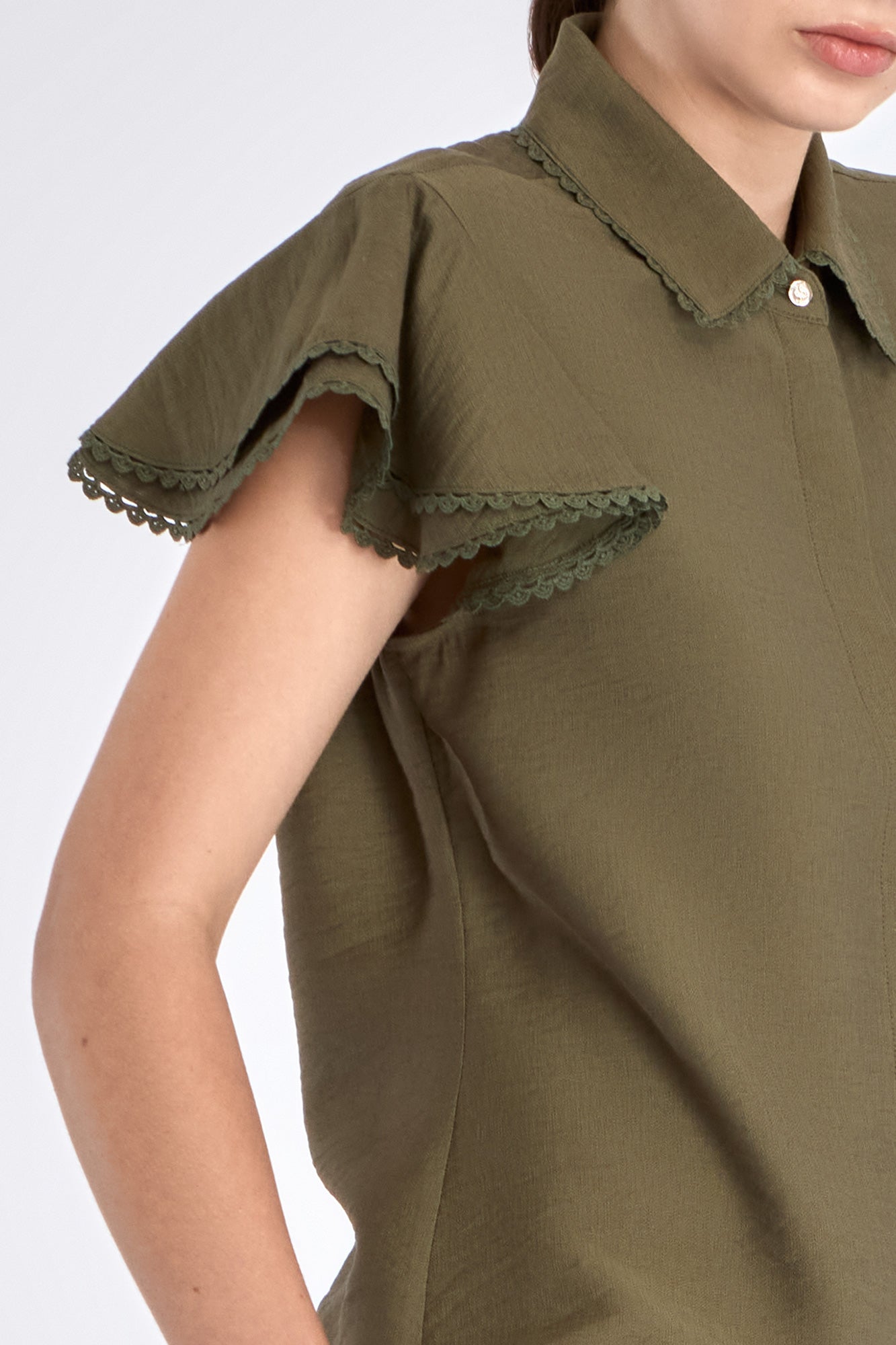 Close-up of the ruffle and tonal trim on the sleeve of the Olive Clark Blouse.