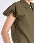 Close-up of the ruffle and tonal trim on the sleeve of the Olive Clark Blouse.