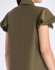 Clean back silhouette of the Clark Blouse, showing the elegant drape of the woven fabric.