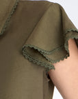 Close-up of the ruffle and tonal trim on the sleeve of the Olive Clark Blouse.