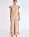 Model wearing the nude Clark Ease Pant, a soft knit trouser with an elastic waist.