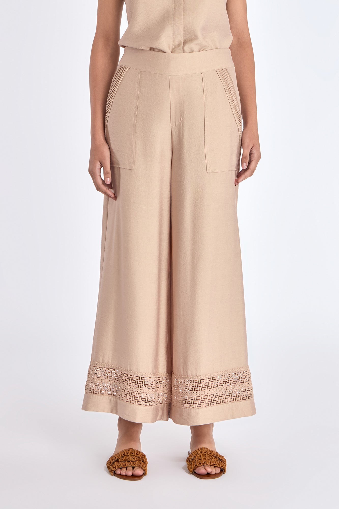 Model wearing the nude Clark Ease Pant, a soft knit trouser with an elastic waist.