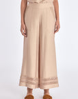 Model wearing the nude Clark Ease Pant, a soft knit trouser with an elastic waist.