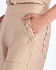 Close-up of the architectural diagonal pocket on the Nude Clark Ease Pant.