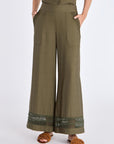 Front view of the Clark Ease Pant in olive, showcasing its soft knit fabric and relaxed fit.