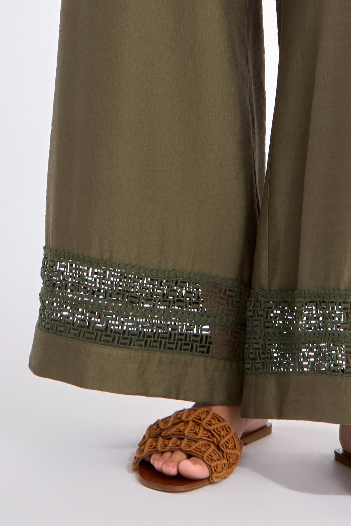 etail of the tone-on-tone trim on the hem of the olive Clark Ease Pant, a soft knit trouser.