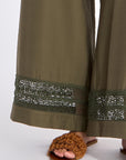 etail of the tone-on-tone trim on the hem of the olive Clark Ease Pant, a soft knit trouser.