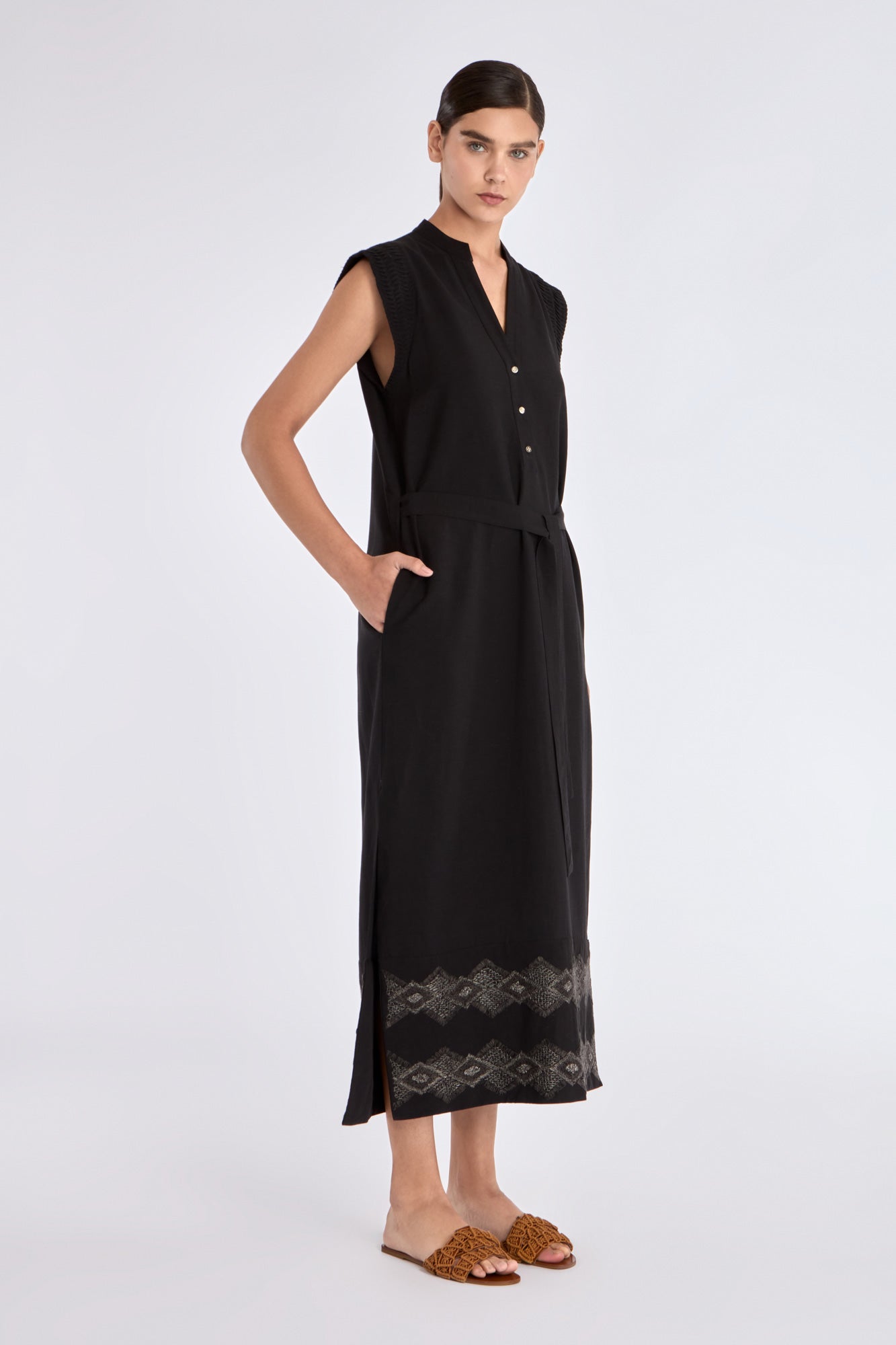 Side profile of the black Denver Dress, highlighting the fluid drape of the linen blend fabric.