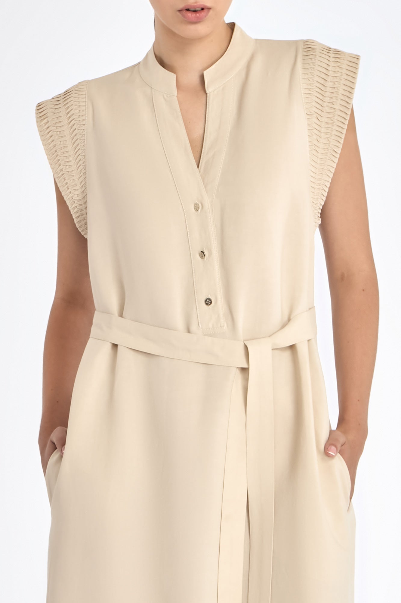 Denver Dress in Ecru – Sleeveless linen midi dress with embroidered hem by AMEDBAM, metal buttons, and fabric belt.