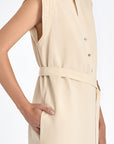 Denver Dress in Ecru – Sleeveless linen midi dress with embroidered hem by AMEDBAM, metal buttons, and fabric belt.