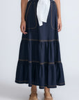 Eden Skirt in Navy – Cotton midi skirt with ruffled hem, front patch pockets, and elasticized back waistband.