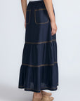 Eden Skirt in Navy – Cotton midi skirt with ruffled hem, front patch pockets, and elasticized back waistband.