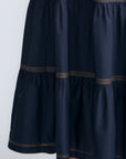 Eden Skirt in Navy – Cotton midi skirt with ruffled hem, front patch pockets, and elasticized back waistband.