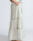 Eden Skirt in Silver – Cotton midi skirt with ruffled hem, patch pockets, and elasticized waistband at the back.