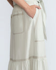 Eden Skirt in Silver – Cotton midi skirt with ruffled hem, patch pockets, and elasticized waistband at the back.