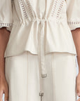 Evangeline Blouse in Prestine – 100% cotton blouse with internal belt, decorative trim, shirt collar, and ¾ sleeves with elastic cuffs.