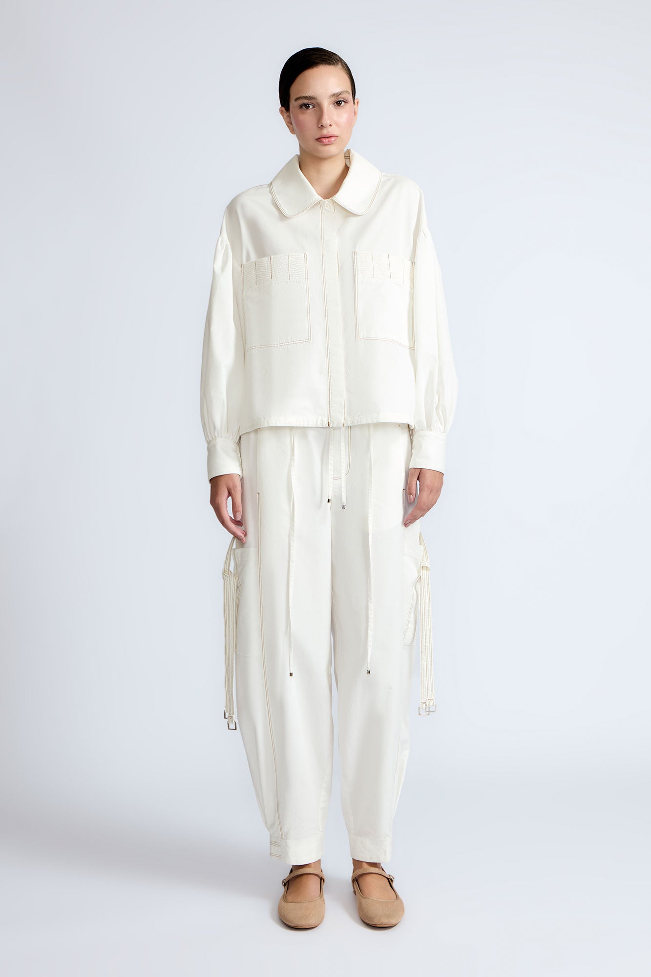 Gwen Jacket in Off White – Cropped cotton jacket with front pleats, shirt collar, and patch pockets.