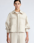 Gwen Jacket in Prestine – Elegant cropped cotton jacket with patch pockets and front pleats for added structure.