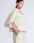 Gwen Jacket in Prestine – Elegant cropped cotton jacket with patch pockets and front pleats for added structure.