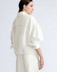 Gwen Jacket in Off White – Cropped cotton jacket with front pleats, shirt collar, and patch pockets.