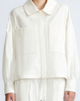 Gwen Jacket in Off White – Cropped cotton jacket with front pleats, shirt collar, and patch pockets.