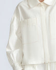 Gwen Jacket in Off White – Cropped cotton jacket with front pleats, shirt collar, and patch pockets.