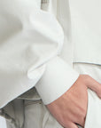 Gwen Jacket in Silver – Cropped cotton jacket with structured pleats, patch pockets, and a modern cut.