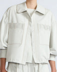 Gwen Jacket in Silver – Cropped cotton jacket with structured pleats, patch pockets, and a modern cut.