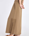 Side profile of the Taupe Indigo Skirt, highlighting the clean silhouette and subtle side slit detail.
